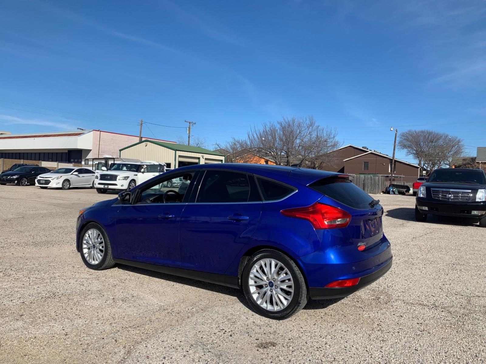 2015 Blue /Black Ford Focus Titanium Hatch (1FADP3N21FL) with an 2.0L L4 DOHC 16V engine, Automatic transmission, located at 1830 North Belt Line Road, Irving, TX, 75061, (469) 524-0199, 32.834373, -96.993584 - Photo #3