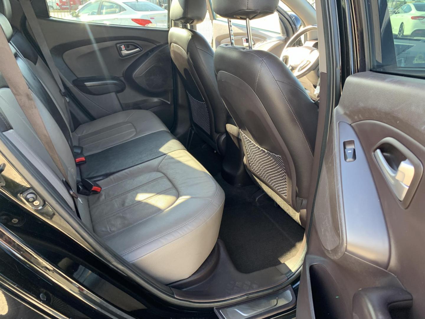 2012 Black /Tan Hyundai Tucson Limited 2WD (KM8JU3AC5CU) with an 2.4L L4 DOHC 16V engine, Automatic transmission, located at 1830 North Belt Line Road, Irving, TX, 75061, (469) 524-0199, 32.834373, -96.993584 - Photo#12